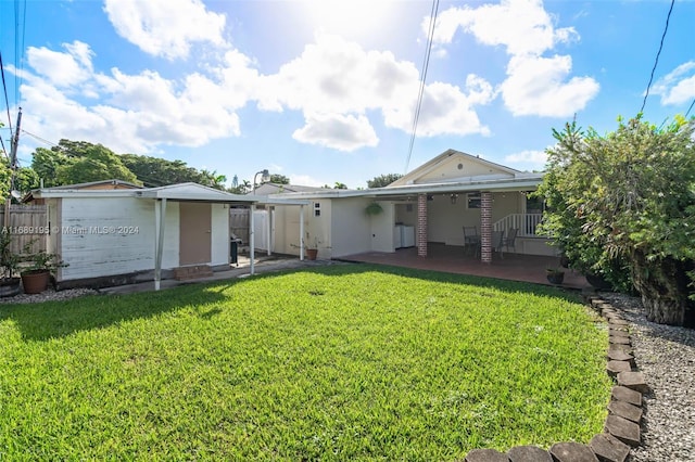 rear view of house featuring a yard