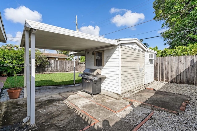 view of patio with grilling area and a storage unit