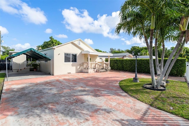 view of front facade with a front lawn and a carport