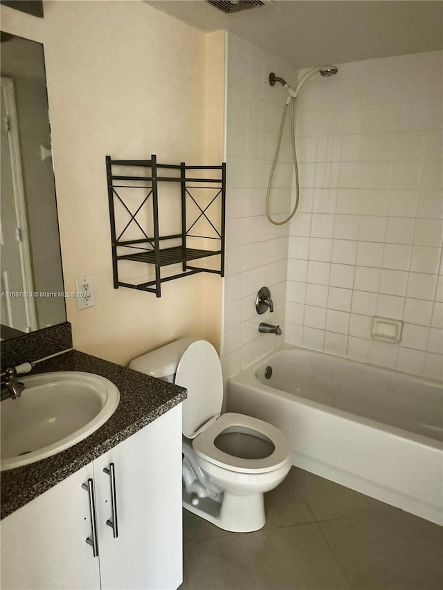 full bathroom with toilet, vanity, tiled shower / bath, and tile patterned flooring