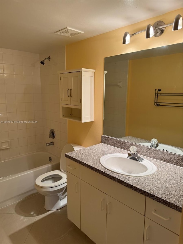 full bathroom featuring tile patterned flooring, vanity, toilet, and tiled shower / bath