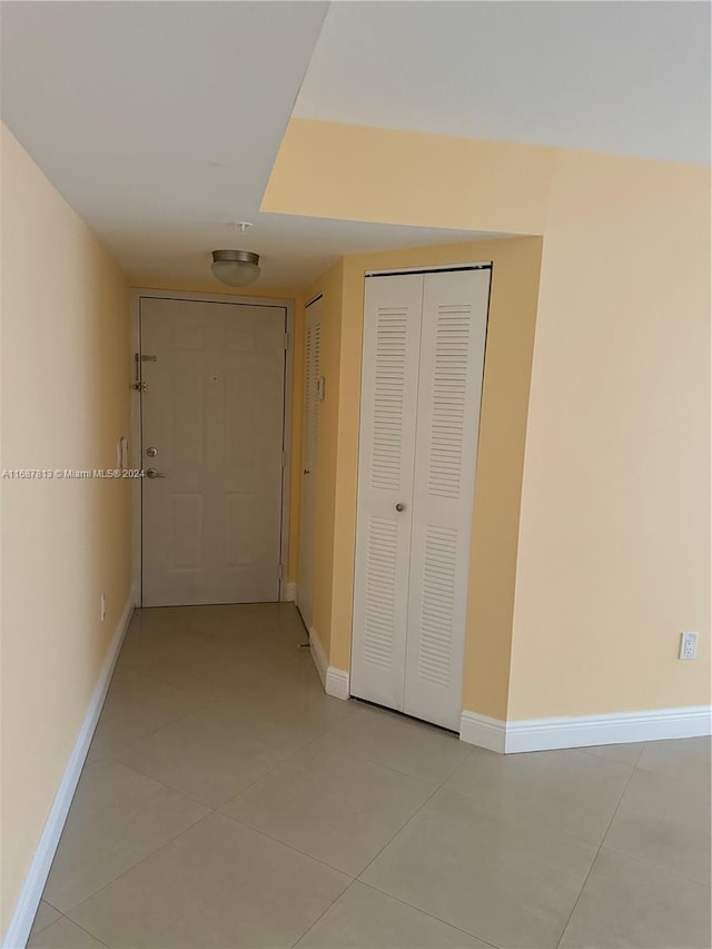 corridor featuring light tile patterned flooring