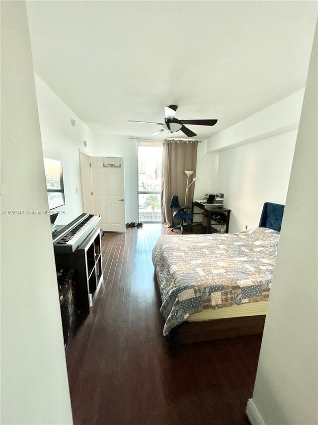 bedroom featuring ceiling fan and dark wood-type flooring