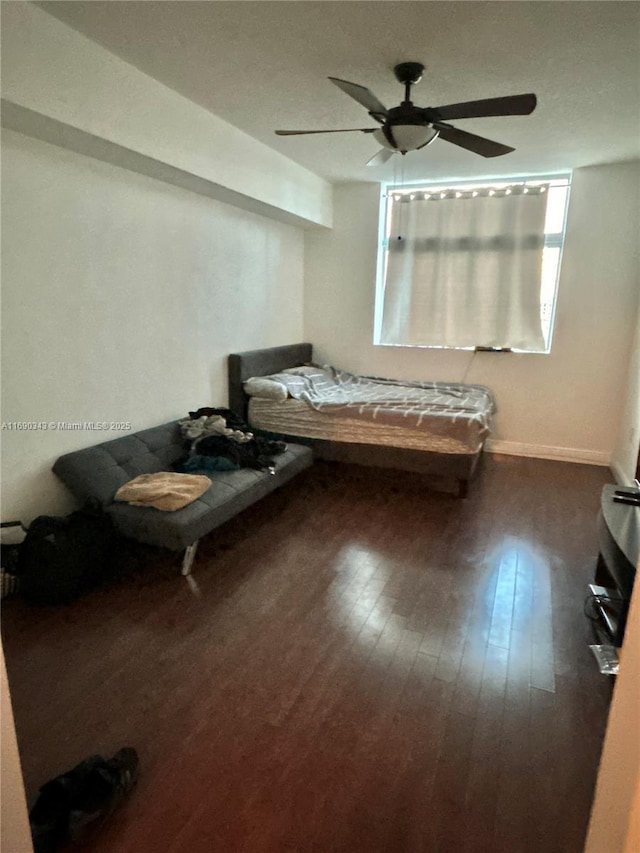 bedroom with ceiling fan and dark hardwood / wood-style flooring