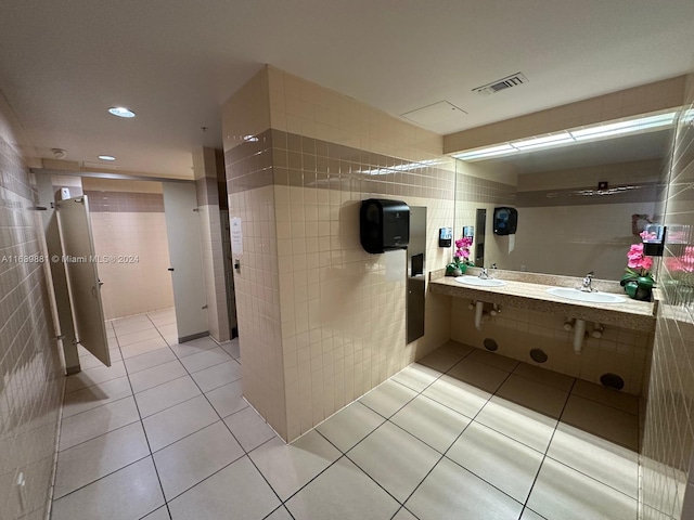 bathroom featuring tile patterned flooring and tile walls