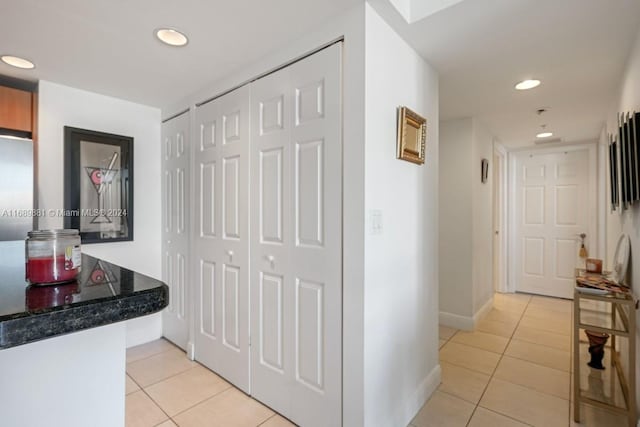 corridor with light tile patterned floors