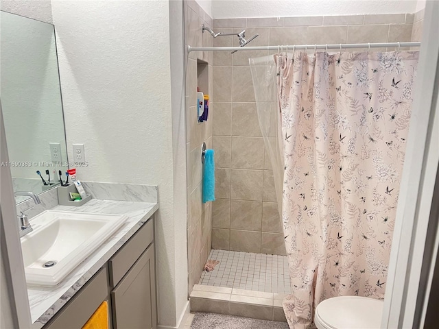 bathroom featuring vanity, toilet, and a shower with shower curtain