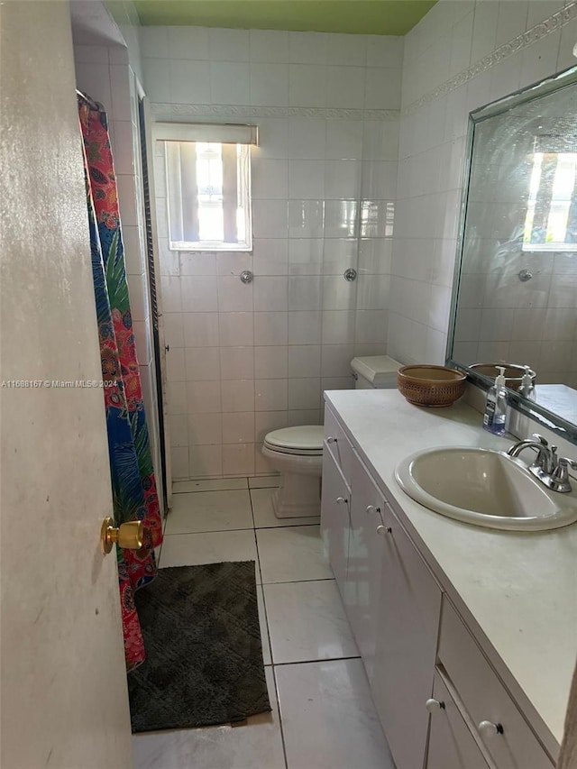 bathroom with toilet, tile walls, tile patterned flooring, vanity, and a shower with shower curtain