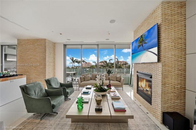 interior space with expansive windows and a tiled fireplace