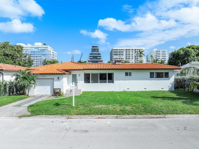 view of front of home featuring a garage and a front yard