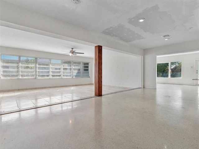 spare room featuring plenty of natural light and ceiling fan