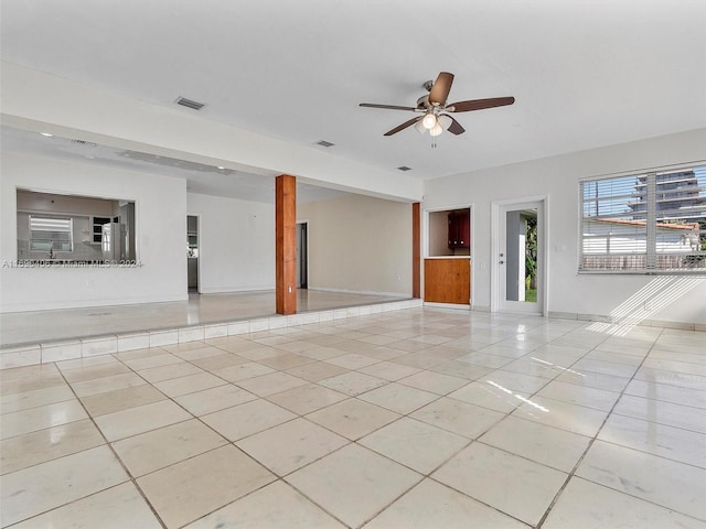 tiled spare room with ceiling fan