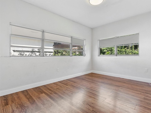 spare room with hardwood / wood-style flooring