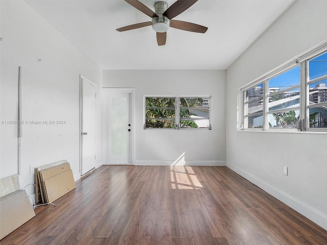 spare room with dark hardwood / wood-style floors and ceiling fan