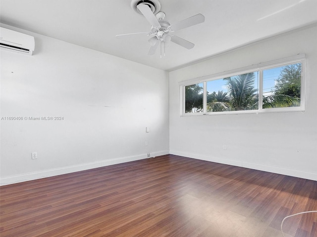 unfurnished room with ceiling fan, an AC wall unit, and dark wood-type flooring