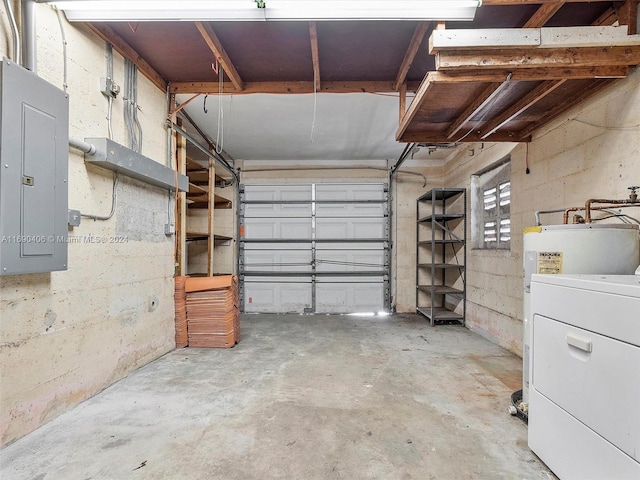 garage featuring electric panel and washer / dryer