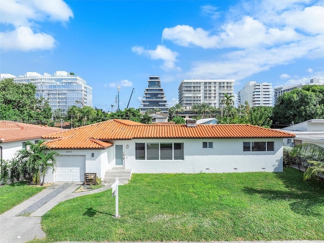 view of front of property with a front yard and a garage