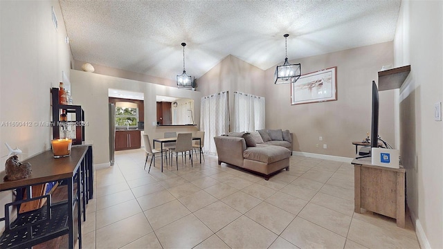 tiled living room featuring a chandelier, a textured ceiling, and vaulted ceiling