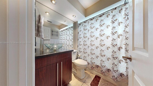 bathroom featuring toilet, vanity, and tile patterned floors