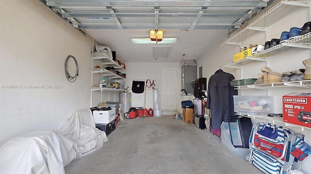 garage with water heater and a garage door opener