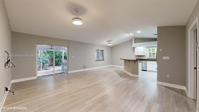 unfurnished living room featuring light hardwood / wood-style floors and lofted ceiling