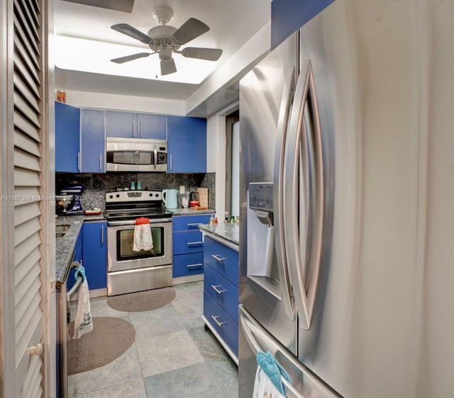 kitchen with backsplash, appliances with stainless steel finishes, light tile patterned floors, blue cabinets, and ceiling fan