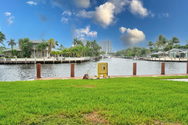 view of dock featuring a water view and a yard