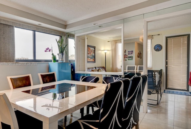 tiled dining area with a textured ceiling and crown molding