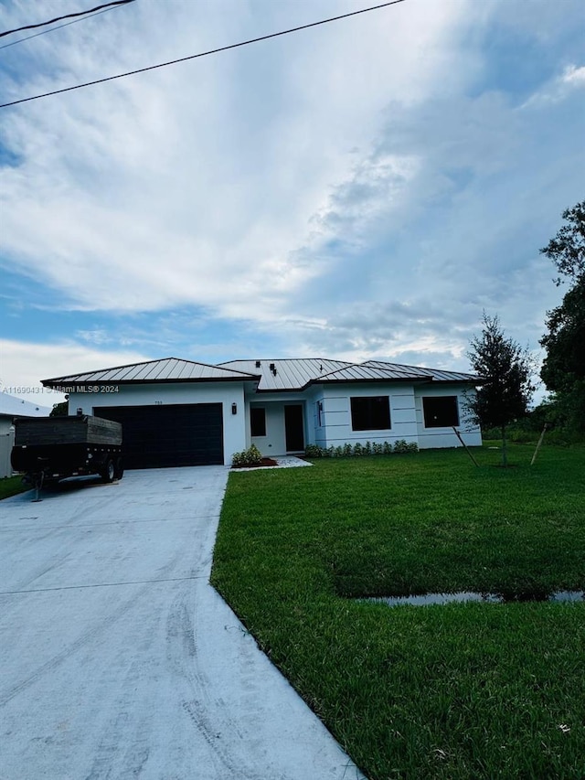 ranch-style house featuring a garage and a front yard