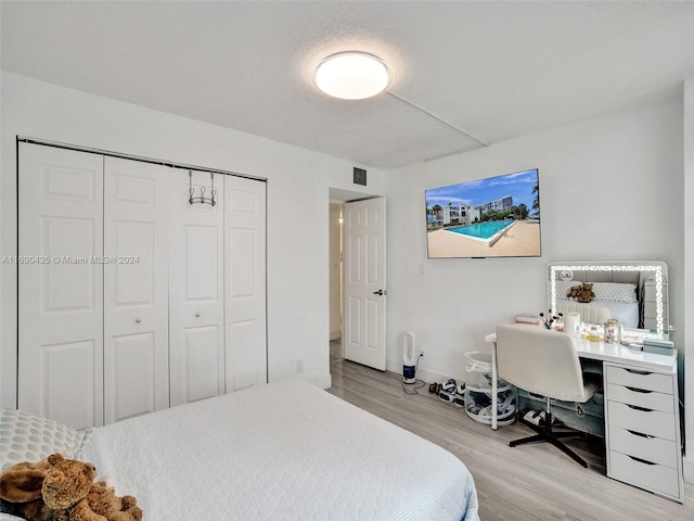 bedroom featuring light hardwood / wood-style flooring and a closet