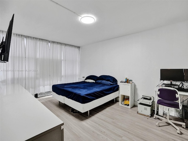 bedroom with light hardwood / wood-style flooring