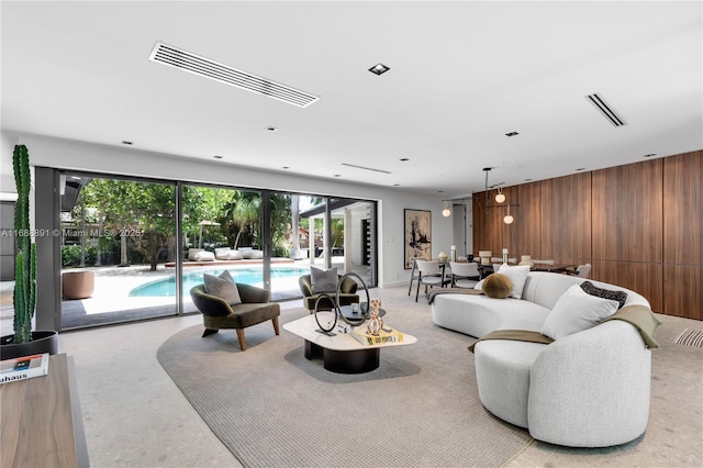 living room with wooden walls and visible vents