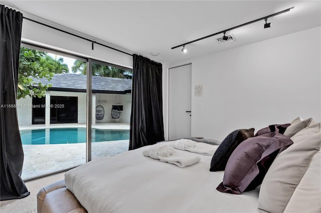 bedroom featuring access to outside, visible vents, and track lighting