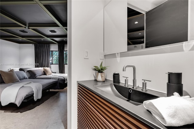 interior space featuring visible vents, white cabinetry, a sink, modern cabinets, and coffered ceiling