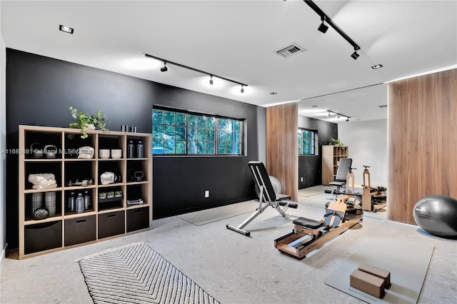 exercise room with rail lighting and visible vents