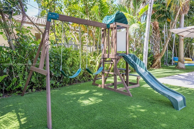 community playground featuring a lawn