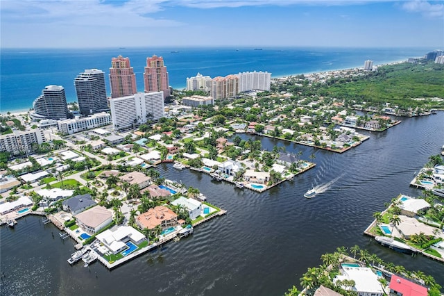 birds eye view of property with a water view and a city view