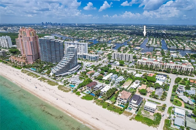 birds eye view of property with a city view, a water view, and a beach view