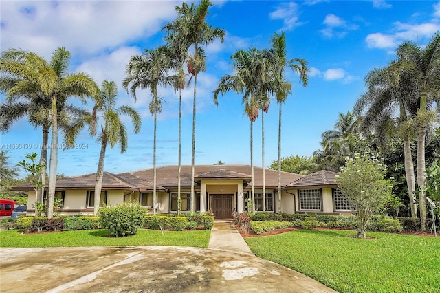 single story home featuring a front lawn