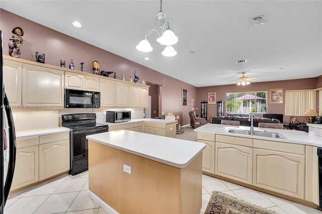 kitchen with black appliances, a center island, hanging light fixtures, sink, and ceiling fan with notable chandelier