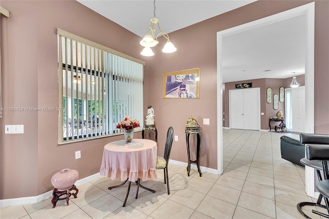 dining space featuring a notable chandelier and light tile patterned floors