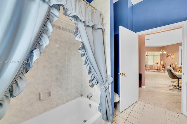 bathroom with tile patterned flooring, shower / bathtub combination with curtain, and toilet