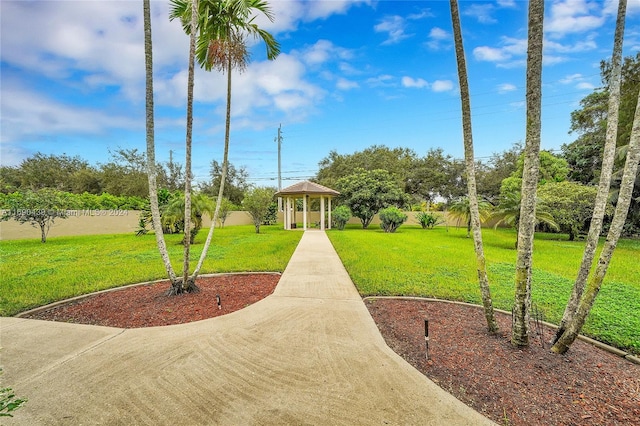 view of home's community with a lawn and a gazebo