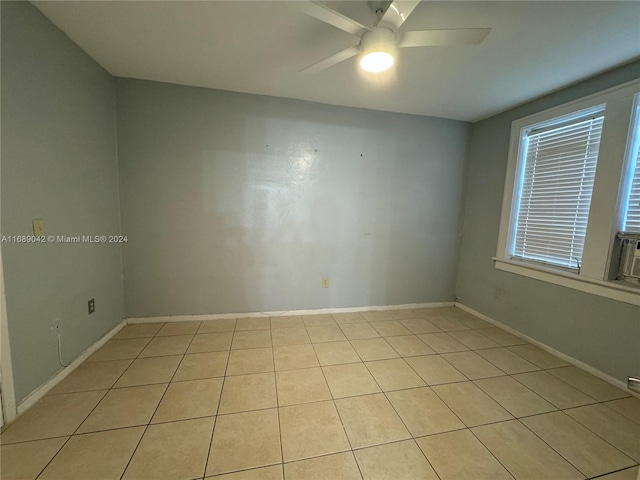 spare room featuring light tile patterned flooring and ceiling fan