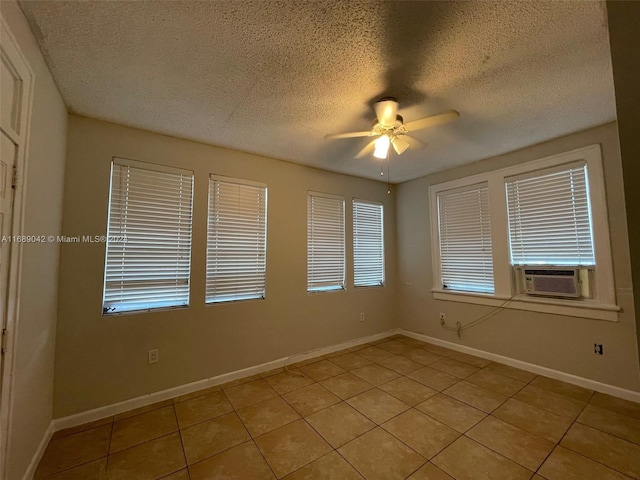 tiled empty room with ceiling fan, a textured ceiling, and cooling unit