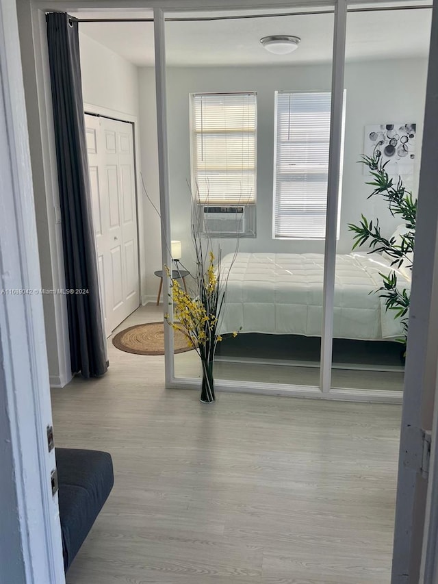 bedroom featuring light hardwood / wood-style floors and cooling unit