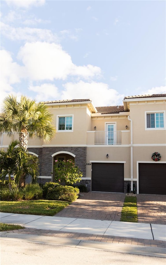 mediterranean / spanish-style house with a balcony and a garage