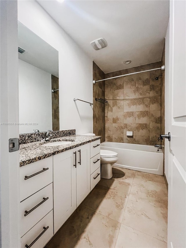 full bathroom with vanity, toilet, and tiled shower / bath combo