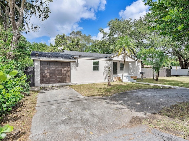 view of front facade featuring a front yard and a garage