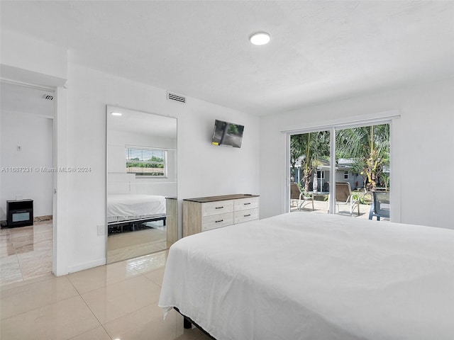 tiled bedroom with access to outside and multiple windows